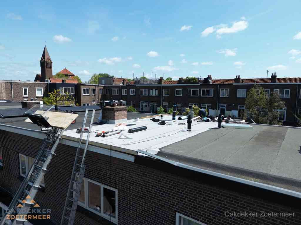 Dakdekkers aan het werk op plat dak in Zoetermeer